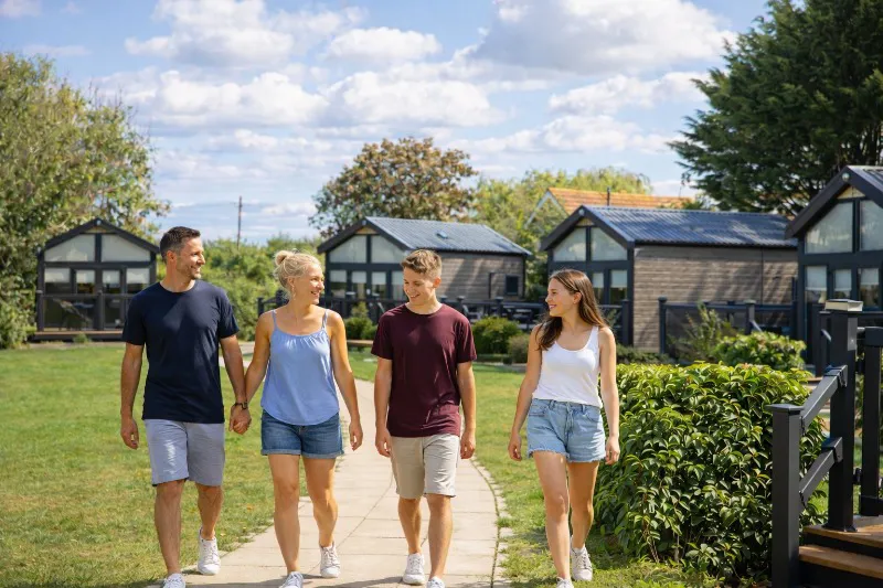 Family walking through the glamping village at Home Farm Holiday Park Somerset